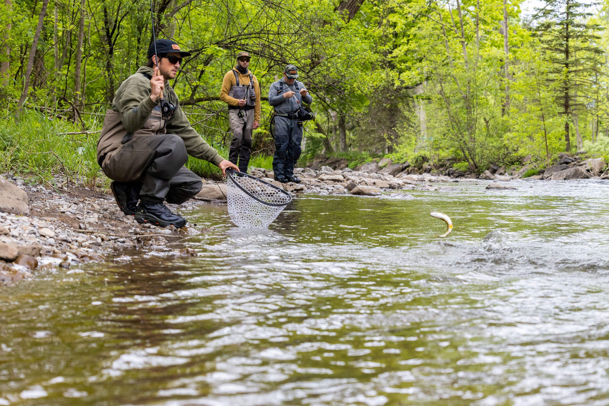 Three men fly fishing