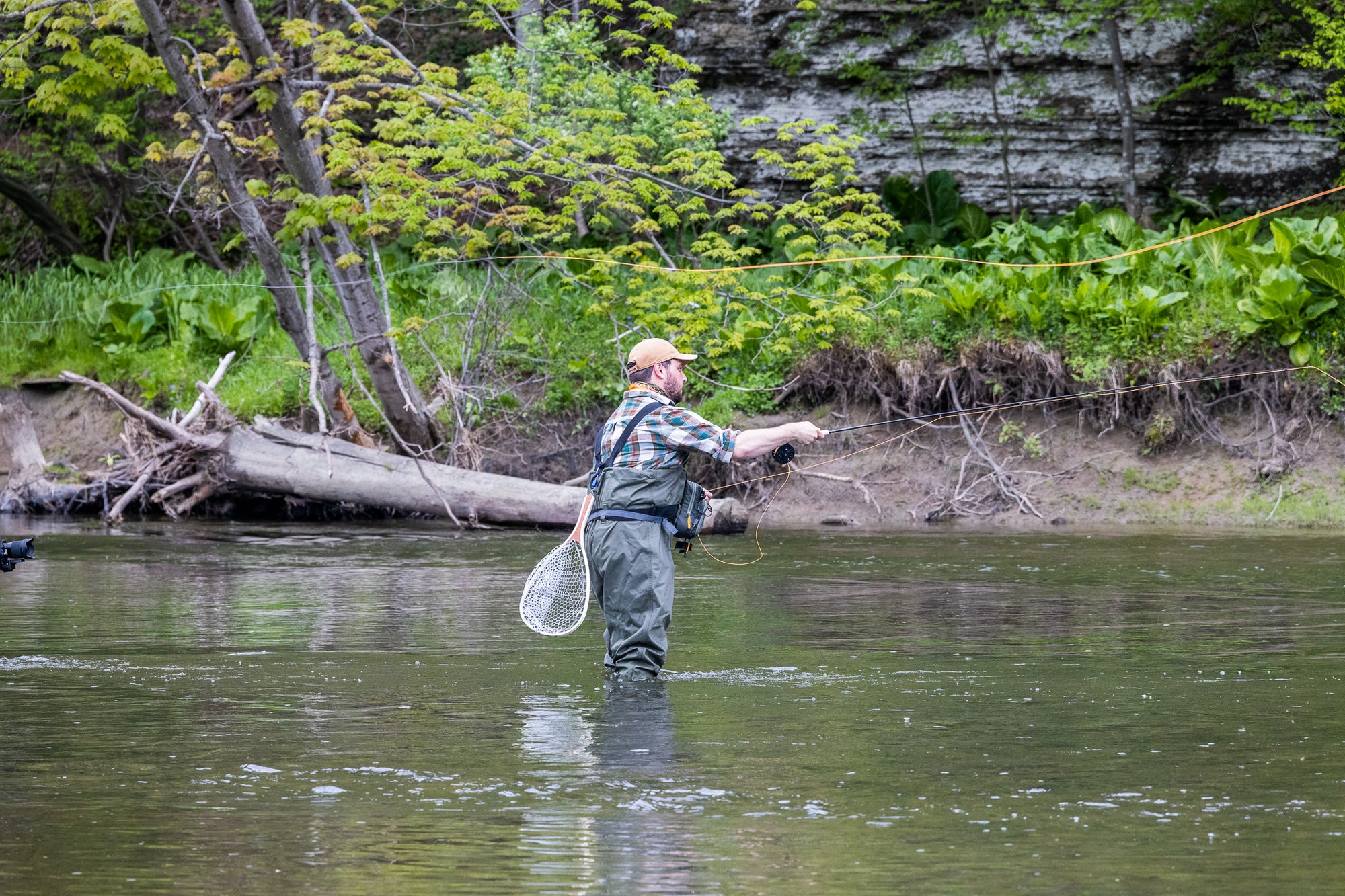 Angler fly fishing in knee deep water