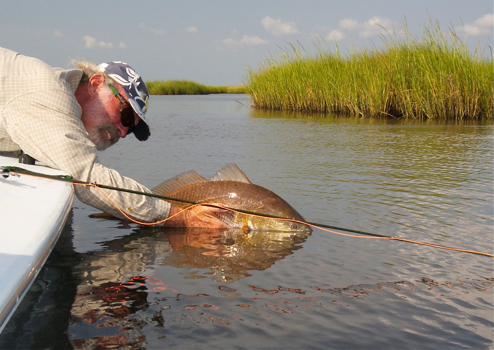 Flip Ballot learning over a boat and releasing a fish back into the water