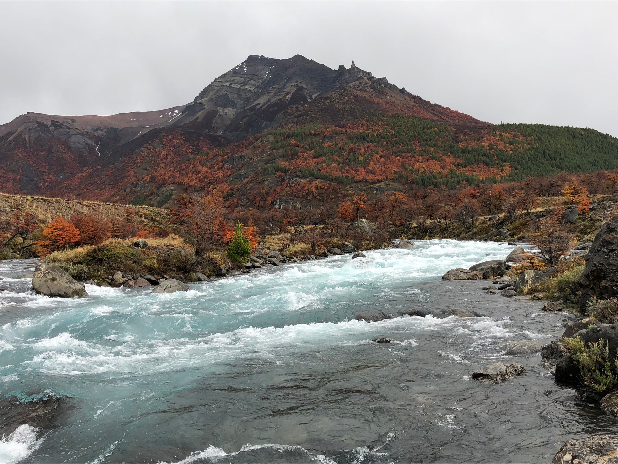 Flowing river with mountains in the background