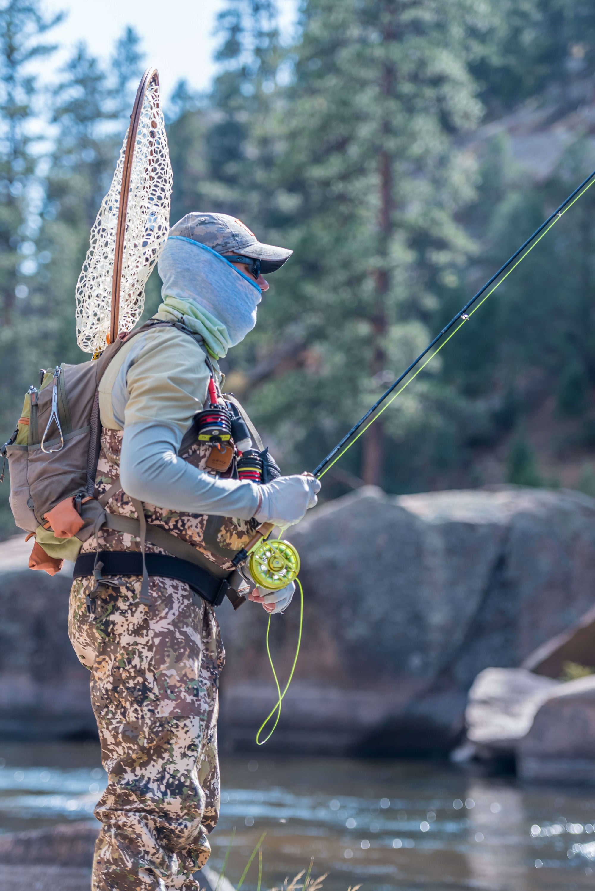 Side view of someone  fly fishing 