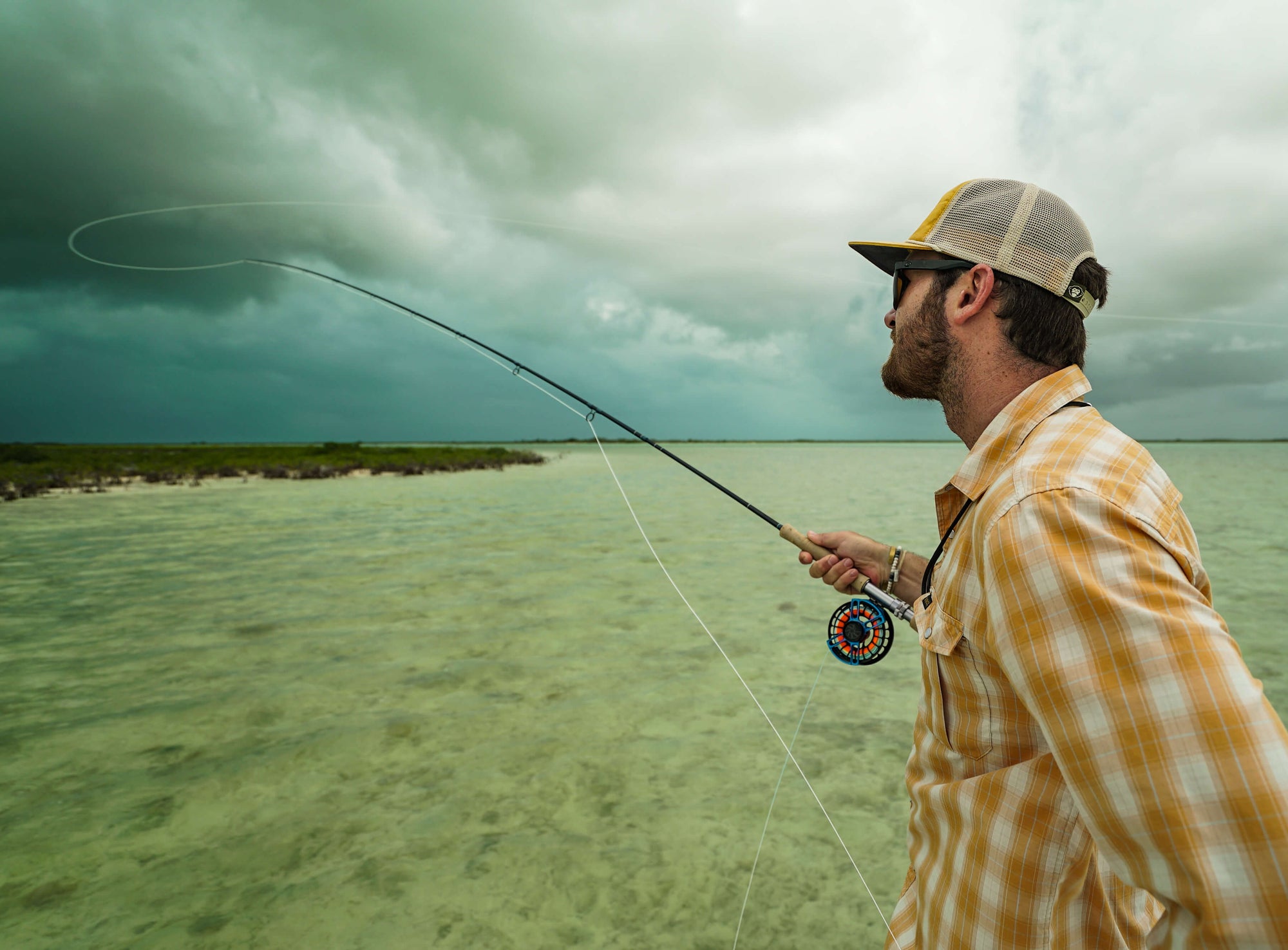 An angler is casting his line. 