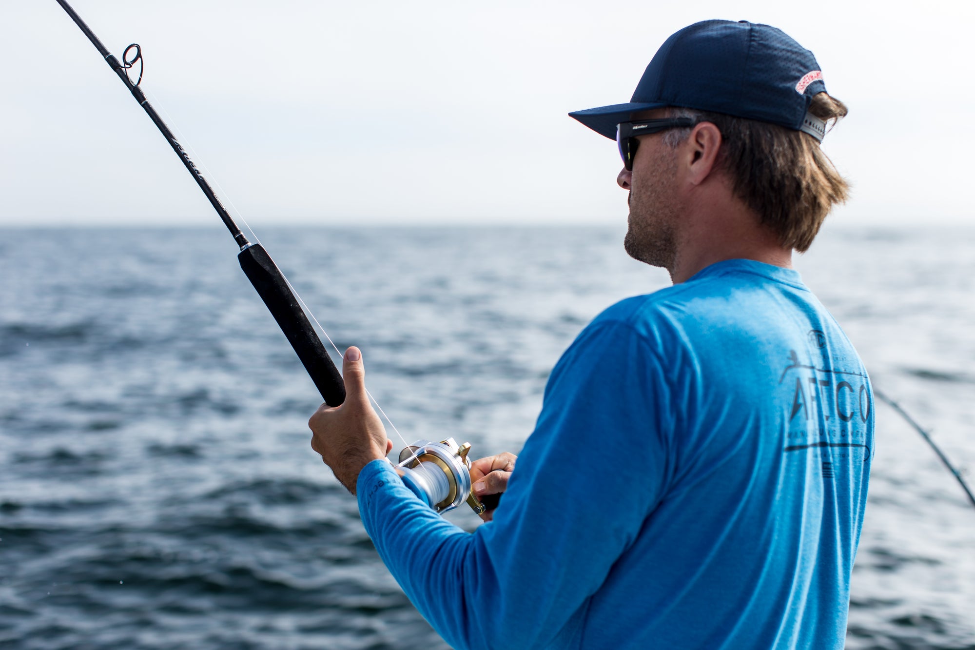 An angler is reeling in his fishing line