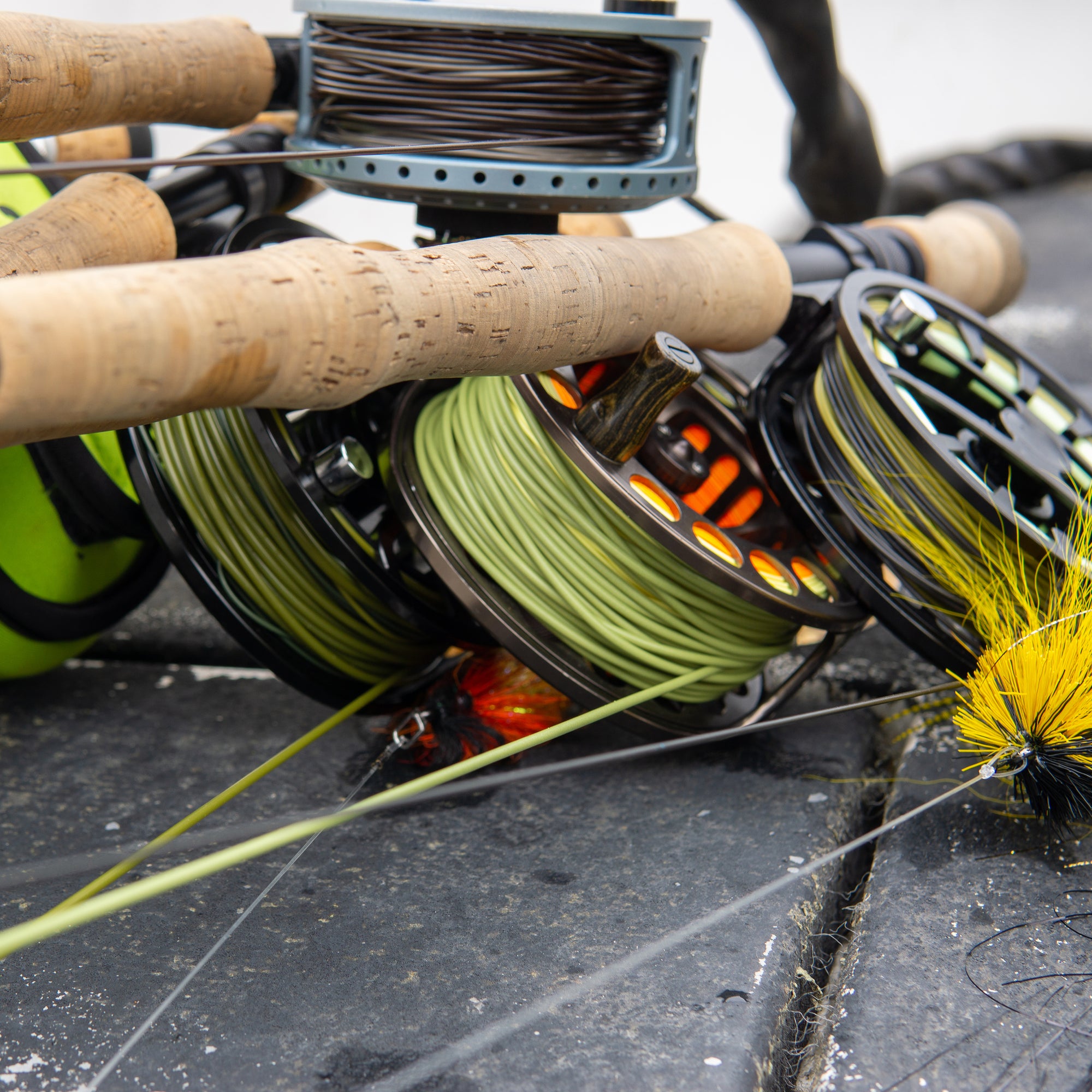 Closeup shot of four fly reels lined with various coils. 